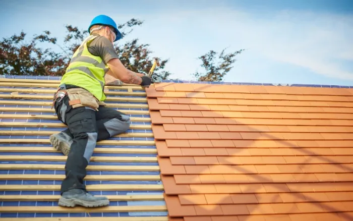 man installing roof