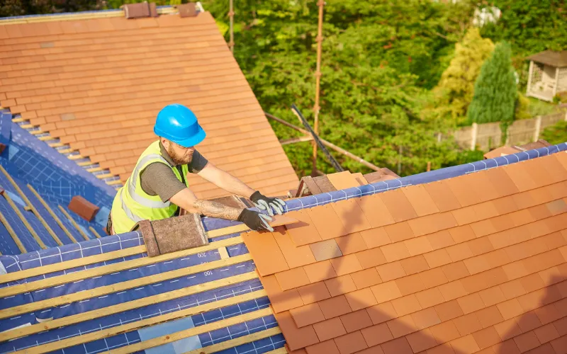 man replacing a roof