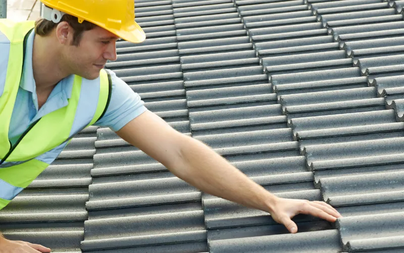 man inspecting a roof