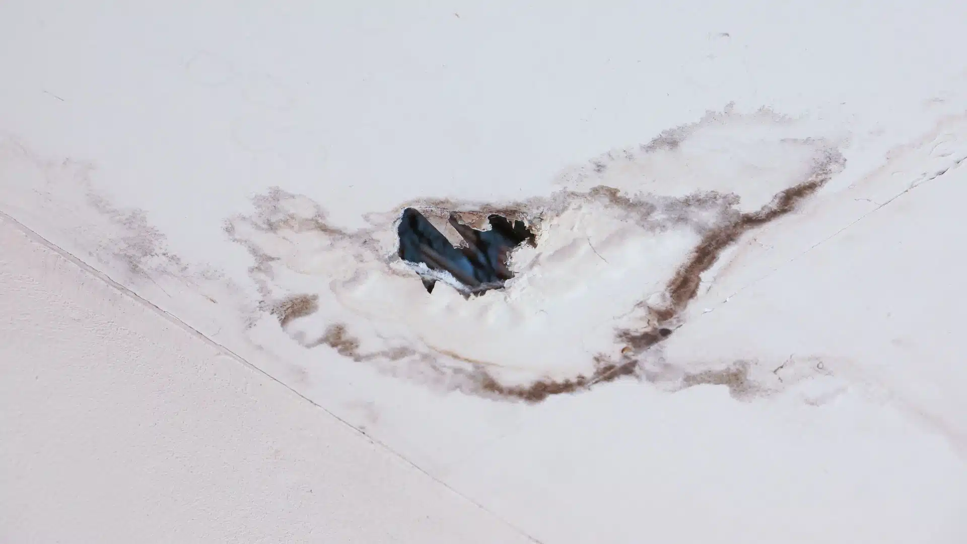 Water damage visible on a ceiling, a common sign of roof issues. A professional roofer Gulfport, MS can help identify and fix such problems.