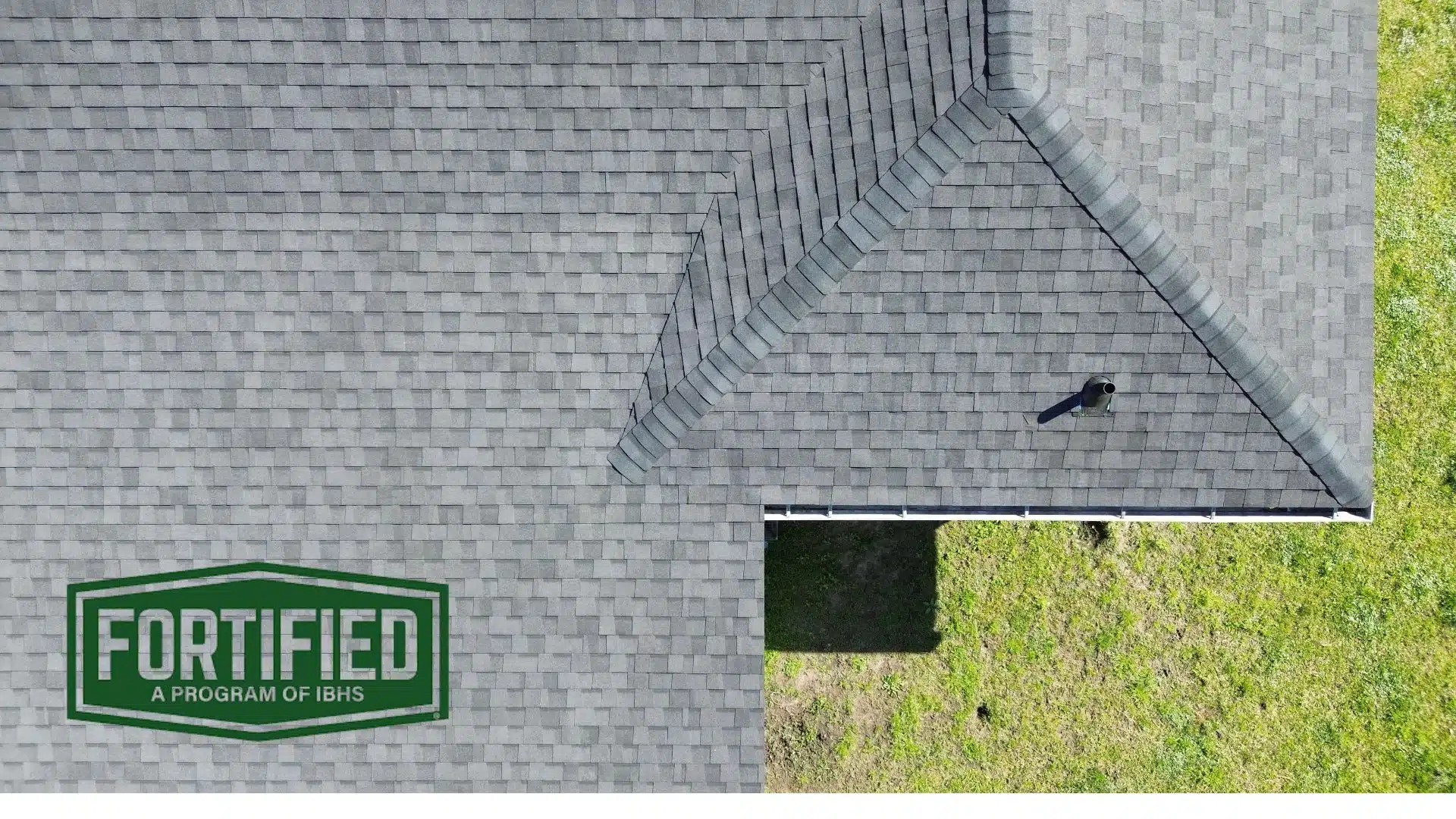 Aerial image of a fortified roof system in Gulfport MS with FORTIFIED™ certification logo, featured in the blog “What Does Fortified Roofing Mean?”