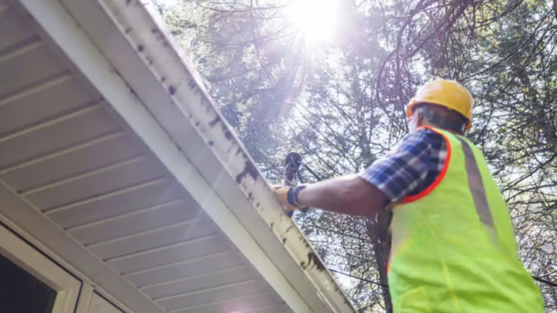 Professional roofer in Gulfport MS inspecting shingle roof for storm damage before hurricane season.