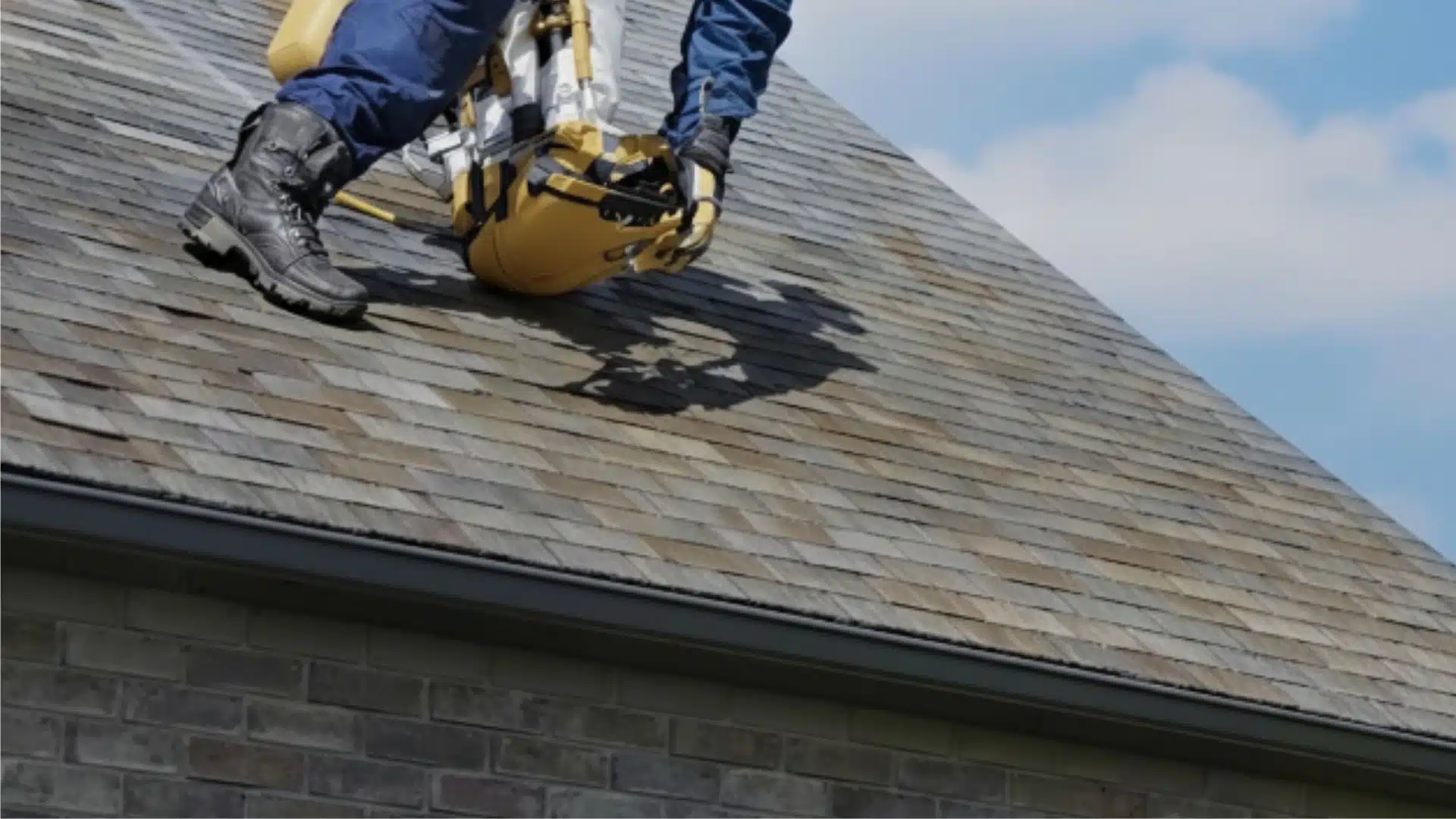 Integrity Roofing technician inspecting a Fortified roof on a Gulfport Mississippi home with coastal sky in background