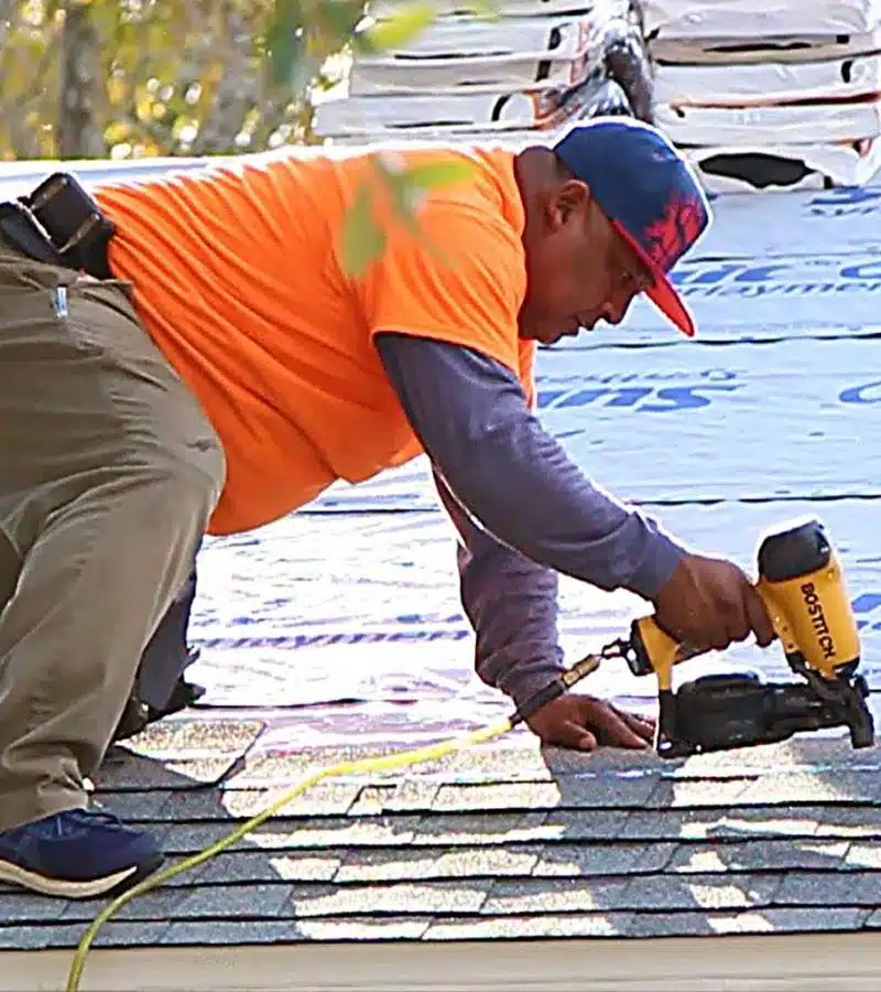 Professional Integrity Roofing roofer installing shingles with a nail gun during a FORTIFIED Roof™ upgrade by Integrity Roofing in Biloxi, Mississippi.