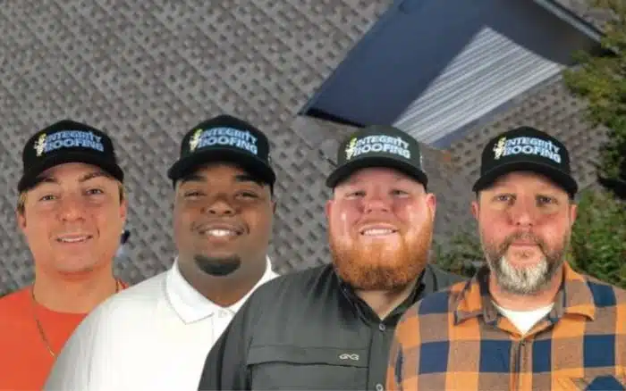 Integrity Roofing team standing in front of a storm-damaged roof, ready to provide 24/7 emergency roofing services in Biloxi, Mississippi and entire MS Gulf Coast