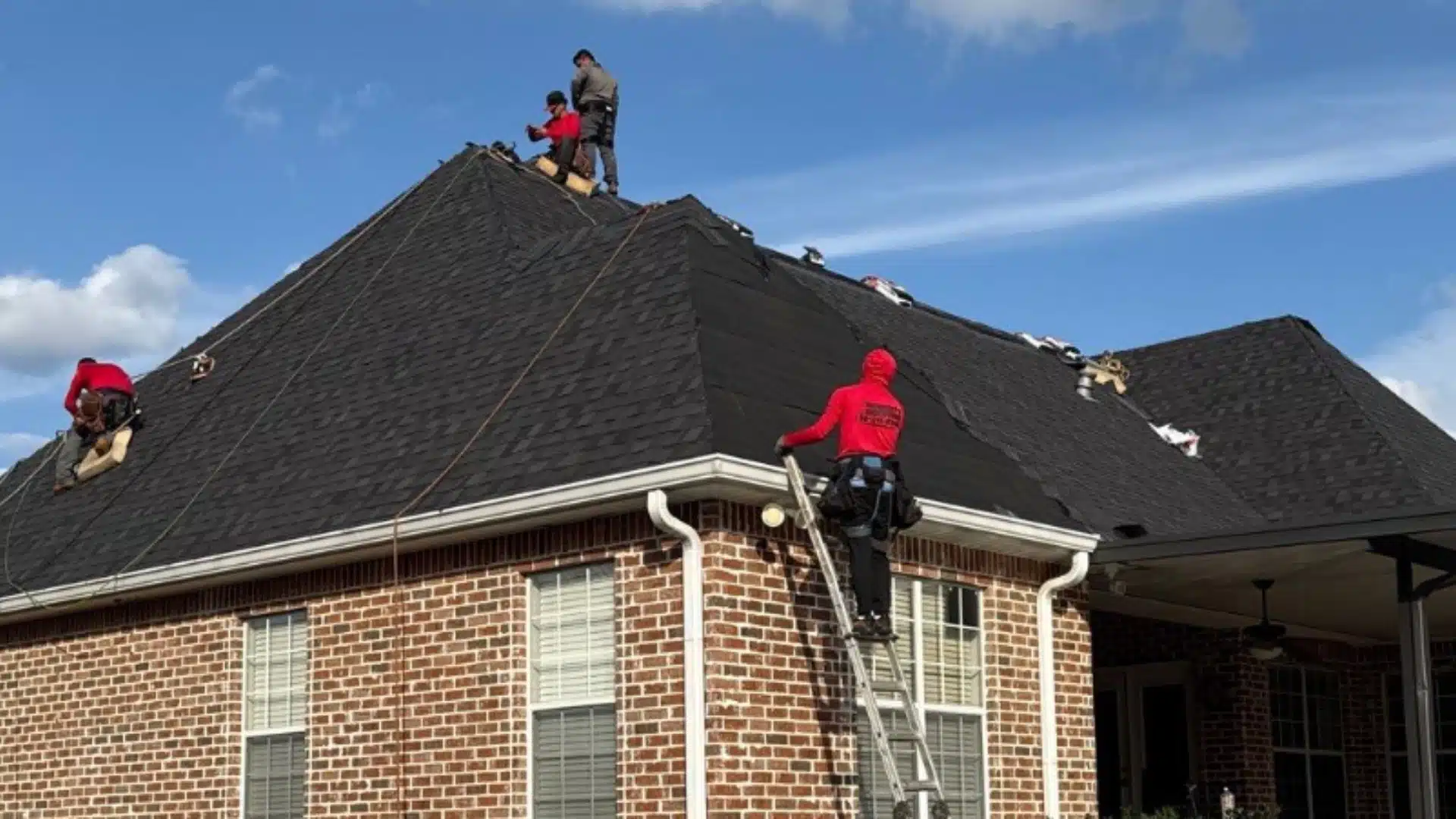 Integrity Roofing team installing synthetic roof underlayment on a residential home in Gulfport MS during a professional roof installation.