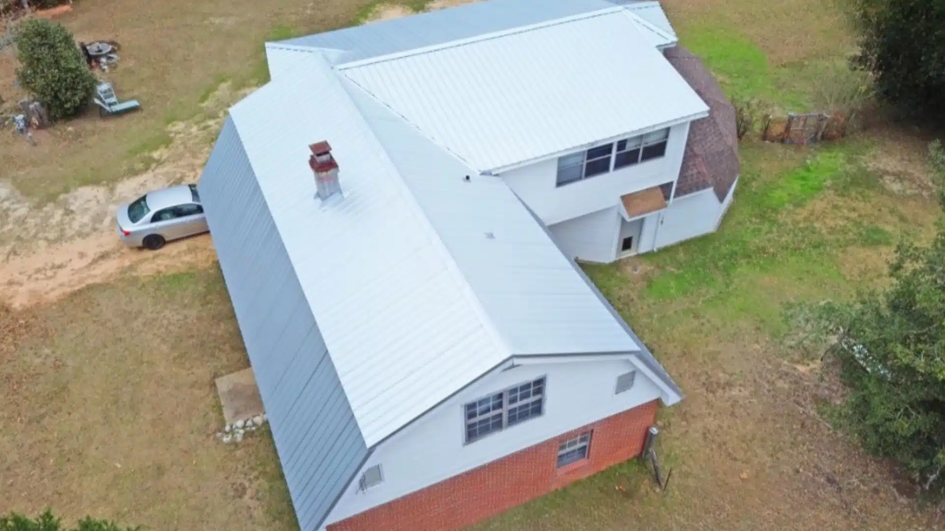 Professional inspection of a metal roof on the Mississippi Gulf Coast showing maintenance checks for fasteners, flashing, and storm protection by Integrity Roofing.